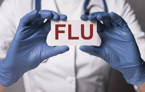 Flu or influenza inscription, word in doctor hands - Photo, image