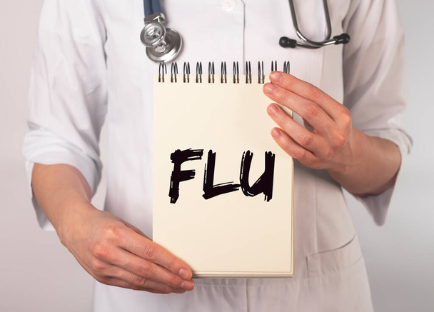 Flu or influenza inscription, word in doctor hands - Fotografie, Obrázek