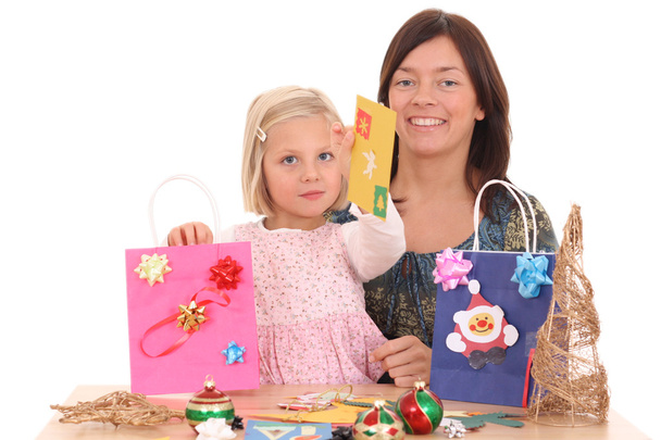mother and 5-6 years old girl making Christmas decoration /all decorations are made by mother and child/ - Photo, Image