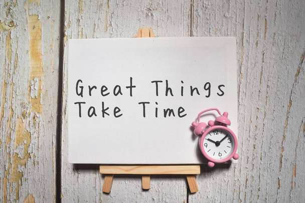 Great Things Take Time on a whiteboard with clock - Foto, Bild