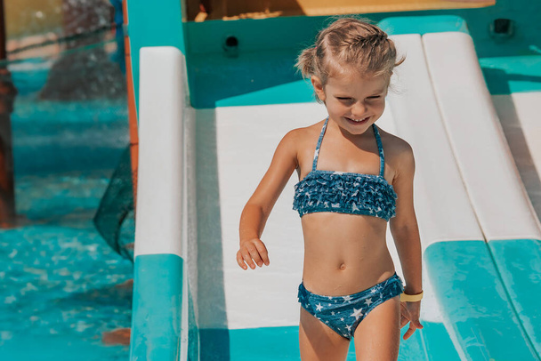 happy little girl splashing around in the pool - Photo, Image