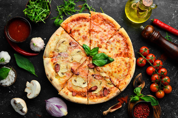 Pizza background. Set of delicious homemade pizzas. On a black background. - Foto, afbeelding