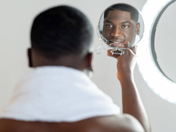 morning grooming hipster black man facial care - 写真・画像