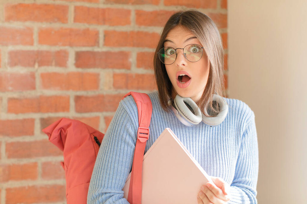 pretty student looking very shocked or surprised, staring with open mouth saying wow - Photo, Image