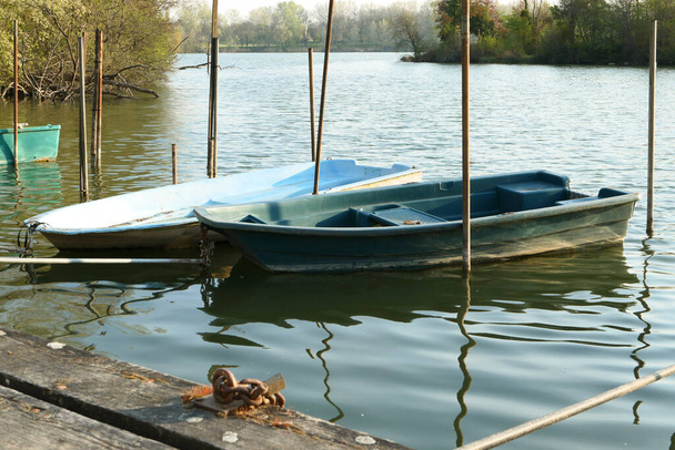 Abandoned rowing boat, isolated on a lake. Two rowboat on water. - Photo, Image