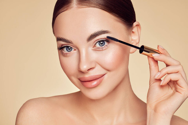 Beauty woman applying black mascara on eyelashes with makeup brush. Eyelash extensions. makeup, cosmetics. beauty, skincare - Фото, изображение