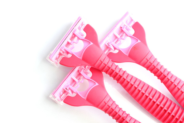 Safety pink plastic razor isolated on white. - Foto, afbeelding