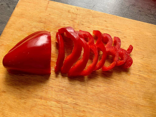 Sliced red peppers on a wooden cutting board. - Photo, Image