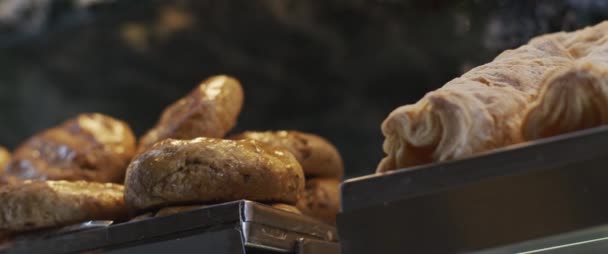 Freshly baked bread and buns in a cafe shop display. Slow motion, close up, - Footage, Video