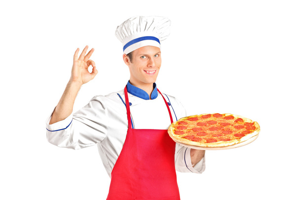 Male chef holding a pizza - Foto, afbeelding