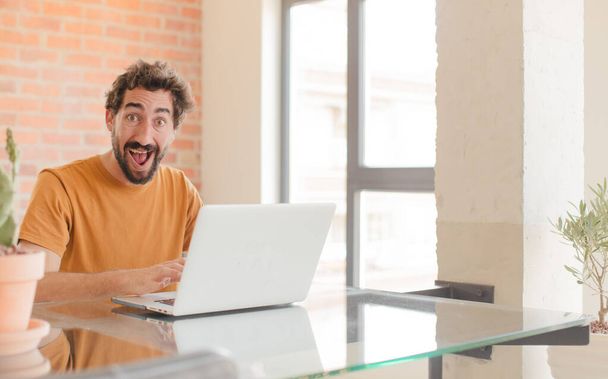 young bearded man working at home with a laptop - Photo, Image