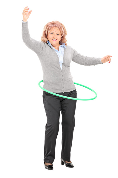 Mature woman spinning hula hoop - Fotografie, Obrázek