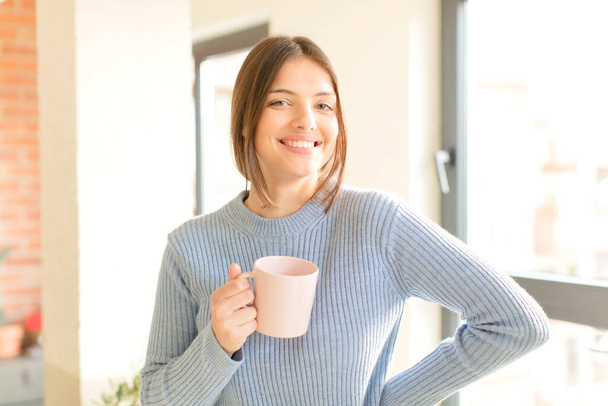 young pretty girl with a coffee mug at home - Фото, зображення