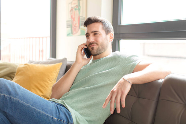 young handsome man using his smartphone at home - Photo, image