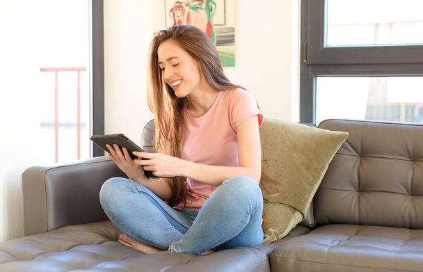 young pretty girl using a tablet pad at home - Φωτογραφία, εικόνα