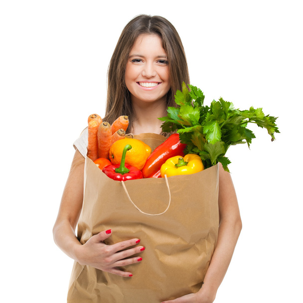 Woman holding a bag full of vegetables - Fotó, kép