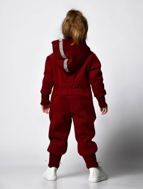Rear view of little preschooler girl wearing warm tracksuit studio portrait - Fotografie, Obrázek