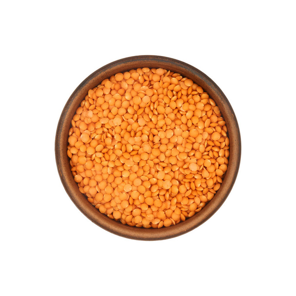 red lentils in simple clay bowl isolated on white background, top view - Photo, Image