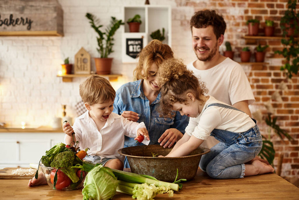 happy family with their children cooking in the kitchen - Foto, Imagen