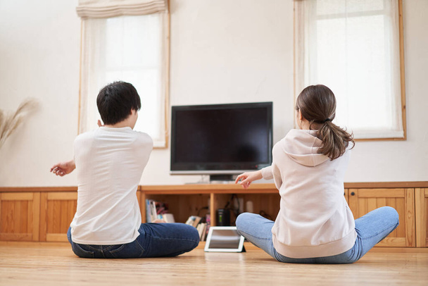 Asian couple stretching in the living room at home - Foto, Imagen