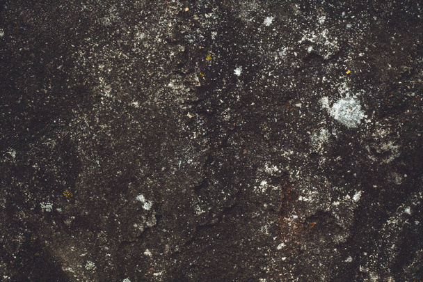 Background texture. Aged dark concrete surface with stones. Top view, copy space - Photo, Image