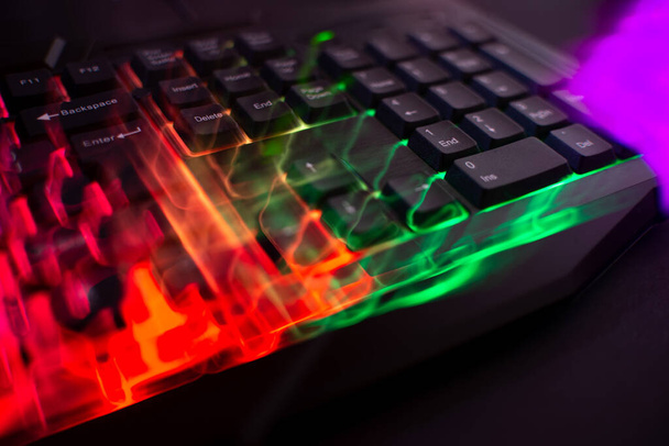 Gaming keyboard with led lights leak on black background - Photo, Image