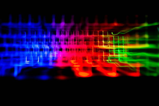 Gaming keyboard with led lights leak on black background - Photo, Image