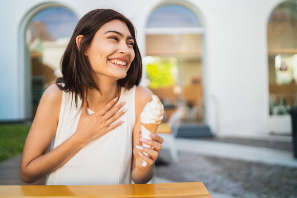 Woman enjoying and eating an ice cream. - Photo, Image