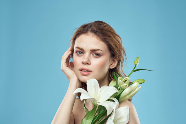 Attractive Lady white flowers blue background portrait cropped view - Photo, Image
