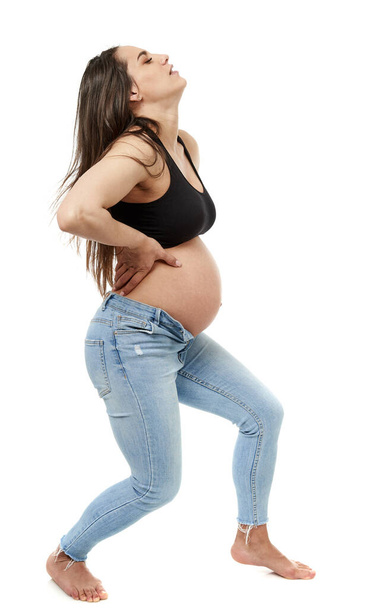 Pregnant woman with back pain, isolated on white background - Fotó, kép