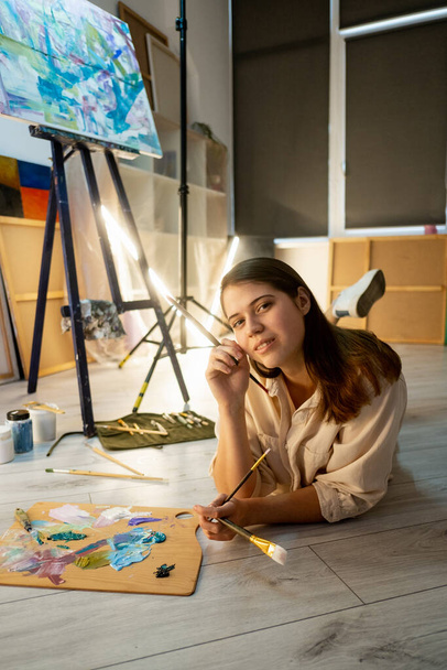 female artist painting school creating artwork - Fotó, kép