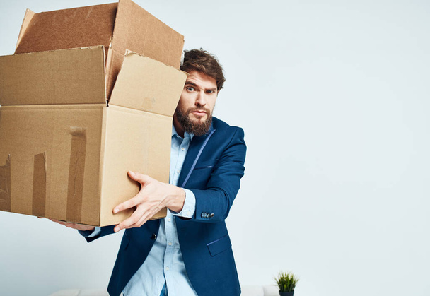 Business man in the office boxes moving to a new location - Фото, изображение