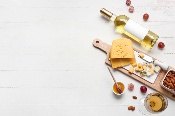 Composition with bottle of wine on white wooden background - Photo, Image