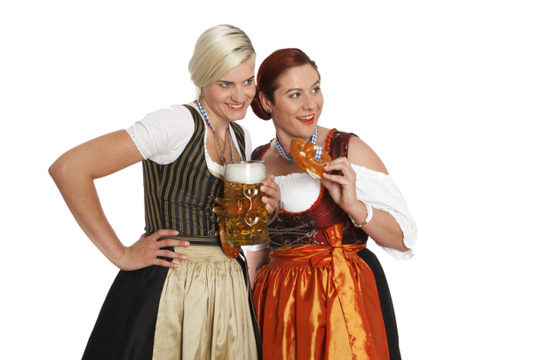 Two bavarian girls with beer in traditional costumes - Foto, Imagem