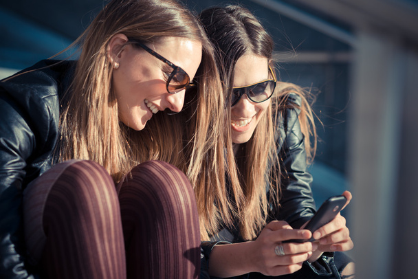 Two women using smartphone - Fotó, kép