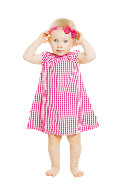 Kleines Mädchen im roten Kleid mit Schleife. Kind isoliert auf weißem B - Foto, Bild