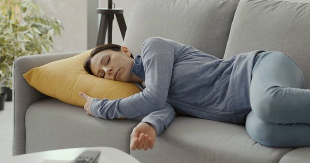 Relaxed woman sleeping on the couch at home - Foto, Bild