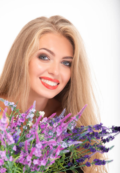 Beautiful blonde woman and flowers on a white background. - Foto, Imagen