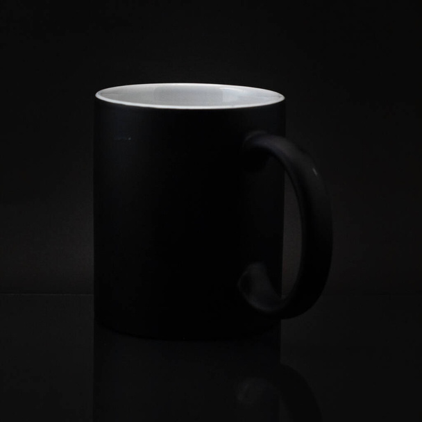 A close up of a black empty ceramic mug isolated - Фото, изображение
