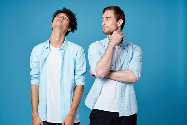 two men in shirts stand next to communication blue background - Photo, Image