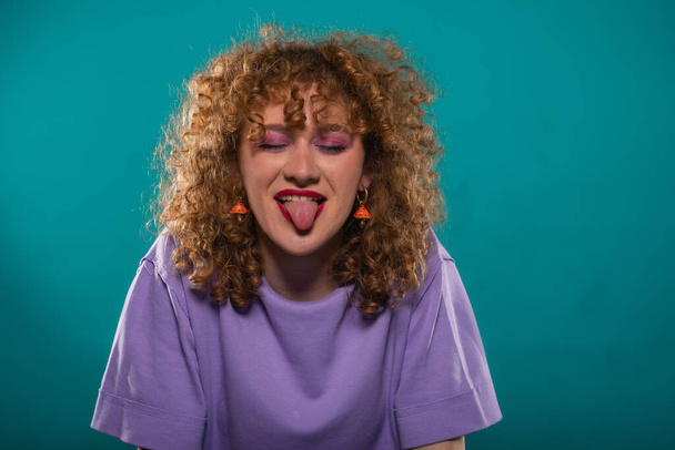 Happy girl is casual dressed while she got her tongue out of her mouth - 写真・画像