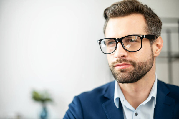 Close portrait of young businessman in elegant black glasses - Foto, Bild