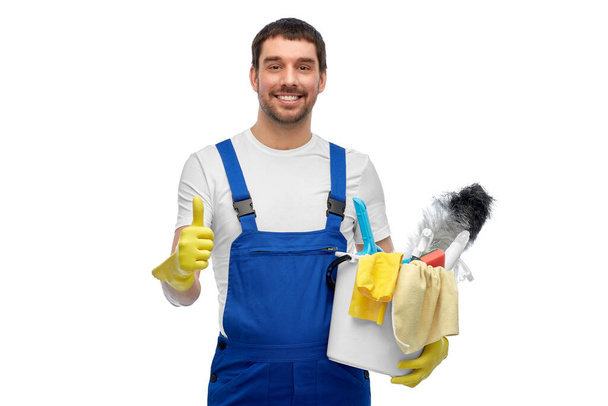 male cleaner in overall with cleaning supplies - Foto, afbeelding