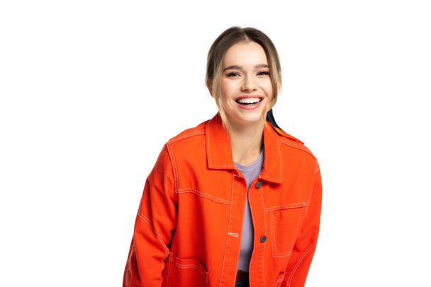 joyful young woman in orange shirt smiling isolated on white  - Foto, Bild