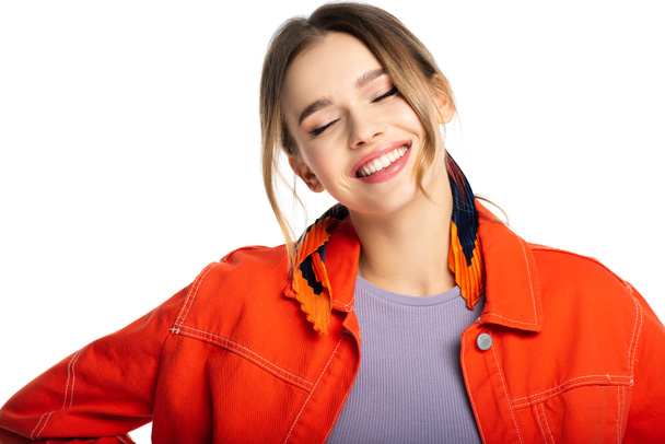 happy young woman with closed eyes in orange shirt isolated on white  - Fotó, kép
