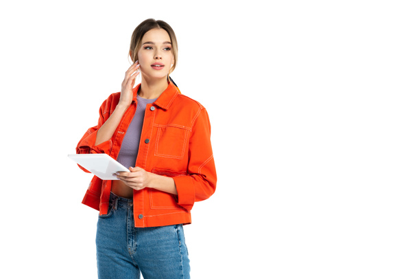 young woman in orange shirt and jeans using digital tablet isolated on white - Φωτογραφία, εικόνα
