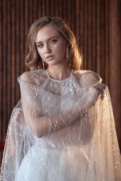 young and beautiful bride blonde in a dark interior. - Photo, Image