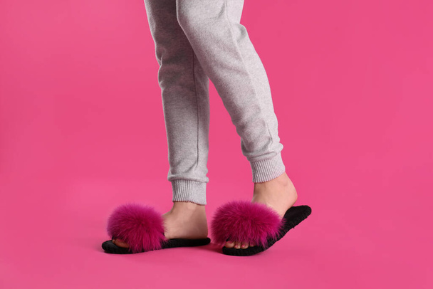 Woman in fluffy slippers on pink background, closeup - Φωτογραφία, εικόνα