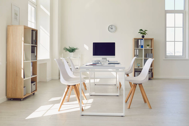 Interior of modern meeting room with big table, comfortable chairs and desktop computer - Φωτογραφία, εικόνα