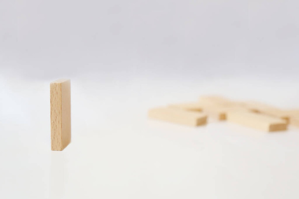 Domino de madeira sobre um fundo branco. Um dominó vale a pena. espaço de cópia - Foto, Imagem